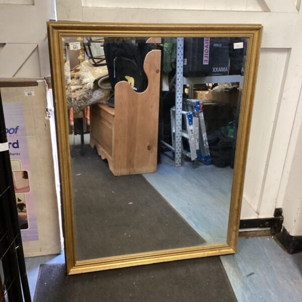 Ornate gilt framed mirror measuring 33x44 inches.