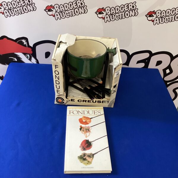Vintage orange Le Creuset fondue set with recipe book.