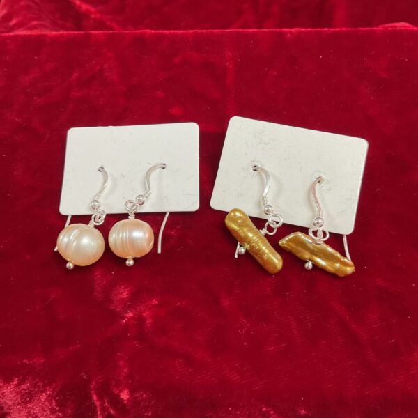 Close-up of pearl and gold tone earrings, vintage fashion jewellery.