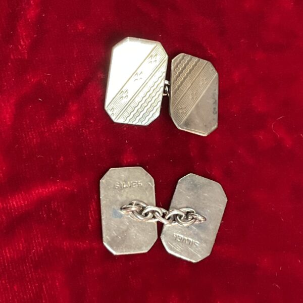 Vintage silver cufflinks with geometric Art Deco design.