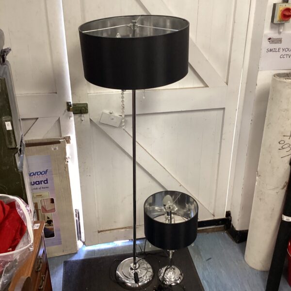 Vintage chrome standard lamp with black shade for home decor.