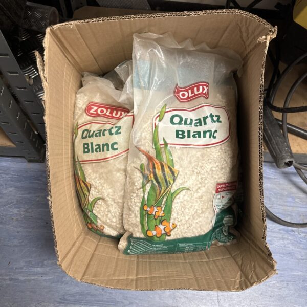 Five bags of Zolux Quartz Blanc aquarium gravel in a cardboard box.