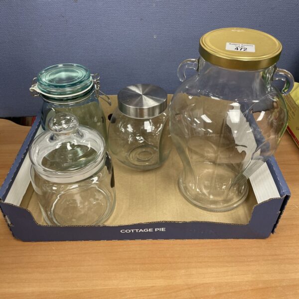 Lot of four vintage glass storage jars for kitchen use.
