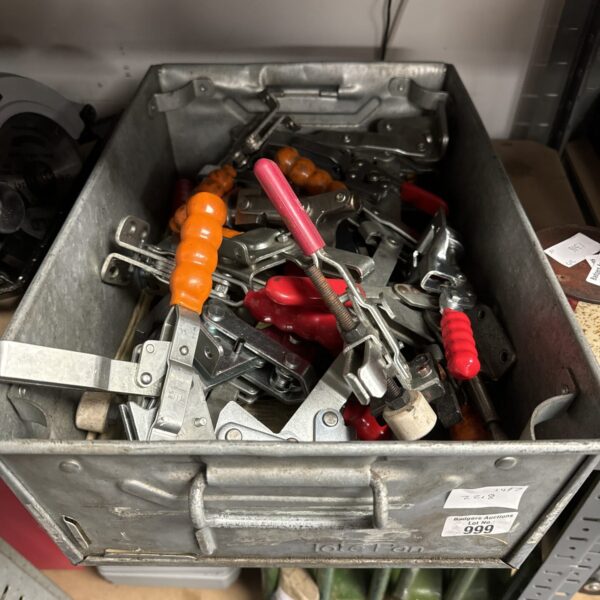 Metal hold down clamps in a tote tray, workshop tools.