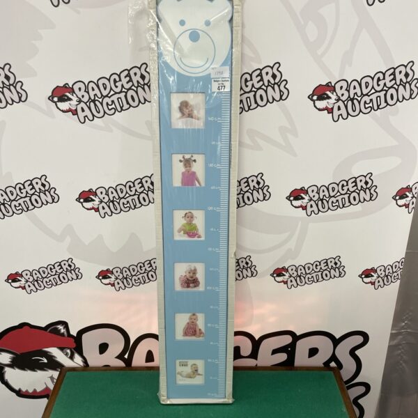 Vintage children’s height chart with wooden frame for photos.