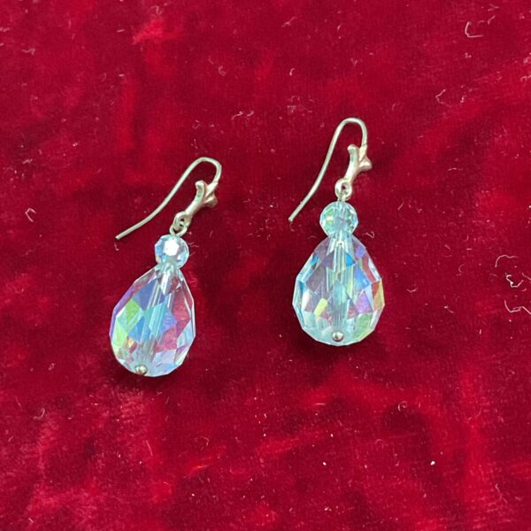 Iridescent gilted crystal drop earrings with yellow metal hooks.