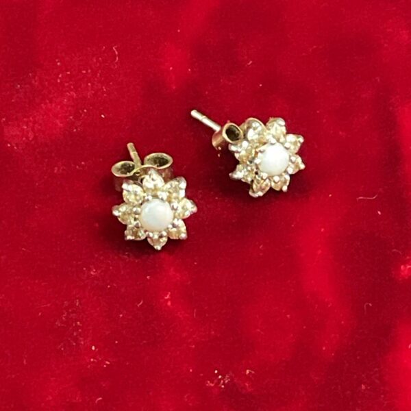Close-up of 9ct gold opal cluster earrings with a vintage style.