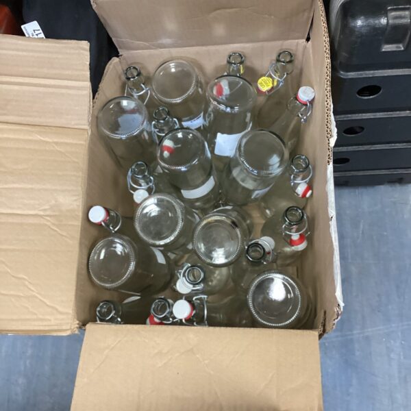 Clear glass drink bottles presented in a cardboard box.