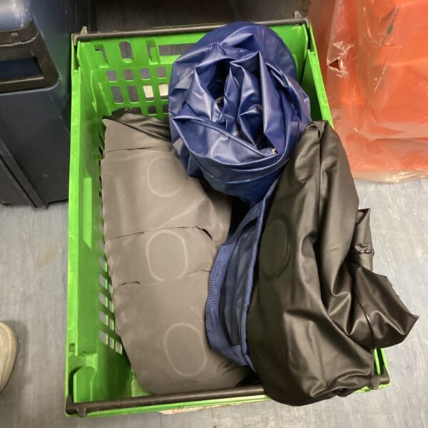 Folded blow up beds lot for camping or guest use.