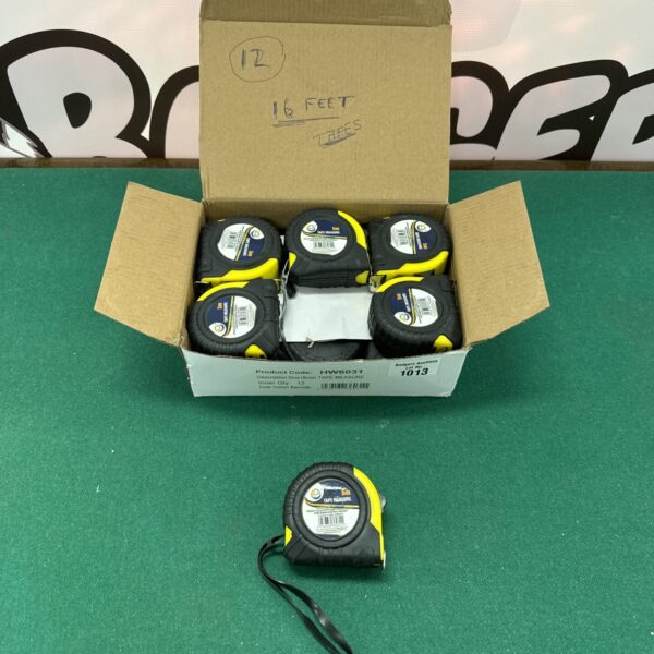Lot of twelve new 5m tape measures in cardboard packaging.
