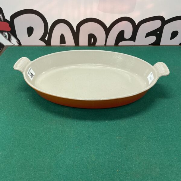 Vibrant orange Le Creuset cast iron casserole dish.