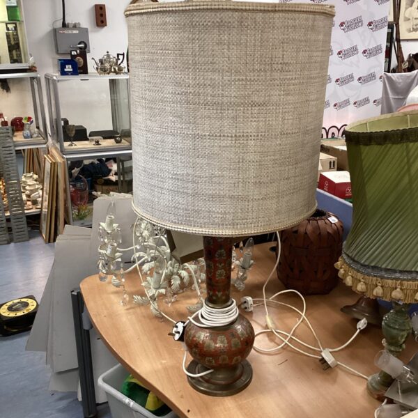Detailed Indian brass table lamp with cream lampshade.