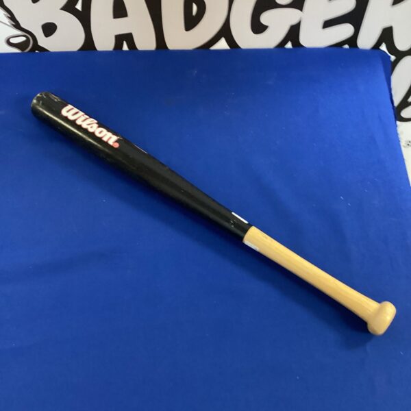 Close-up of a child's Wilson wooden baseball bat.