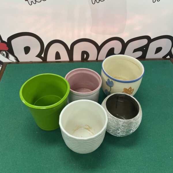Group of five mixed ceramic plant pots for garden or home.