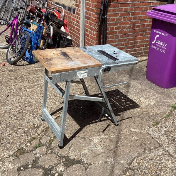 Portable Wolfcraft saw bench in a garden setting.