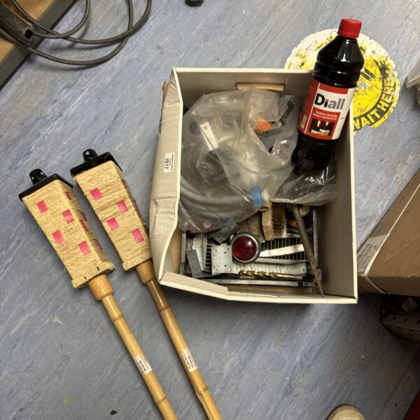 Two bamboo garden citronella burners with a box of shed items.