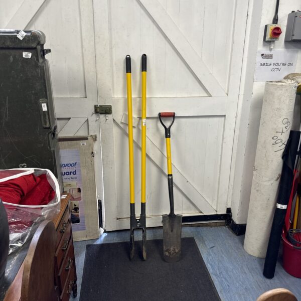 Yellow handled post hole digger and spade garden tool.