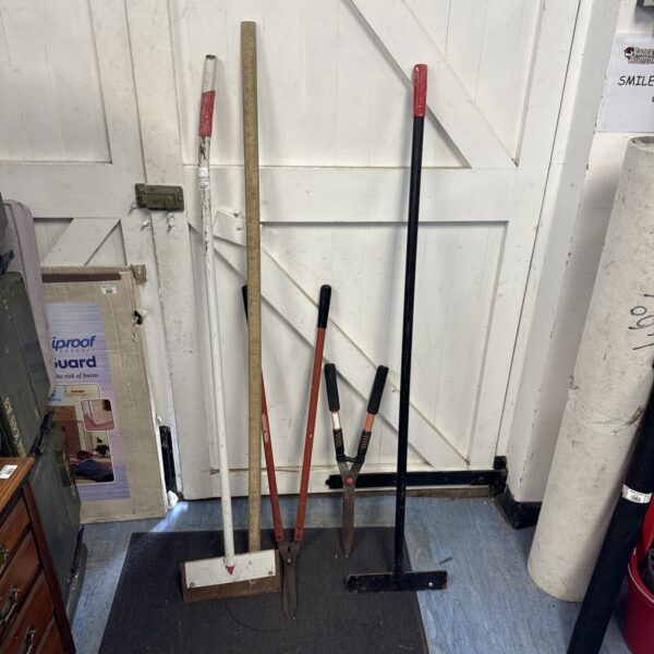 Selection of vintage garden tools including spade and fork.