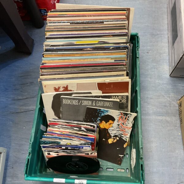 A crate filled with a diverse vinyl record collection.