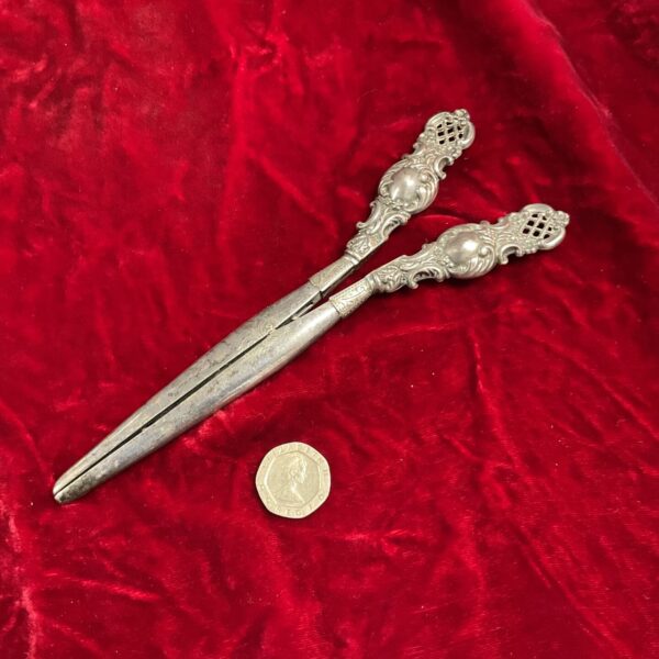 Antique German silverplate glove stretchers with ornate handles.