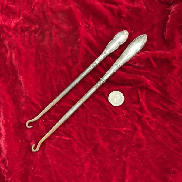 Antique silver button hooks for Victorian clothing.