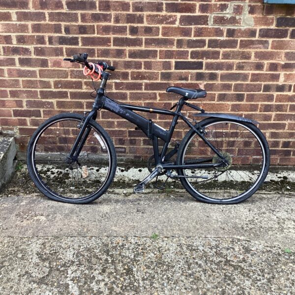 Black Dahon folding bike, ideal for city commuting and portability.