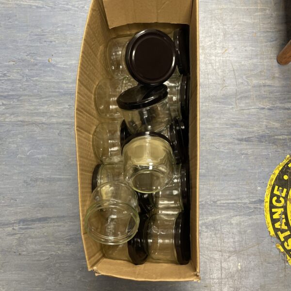 Collection of small glass jars with lids for storage.