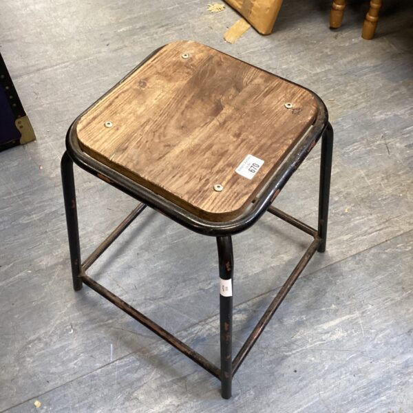 Vintage metal stool with wooden seat, industrial style.