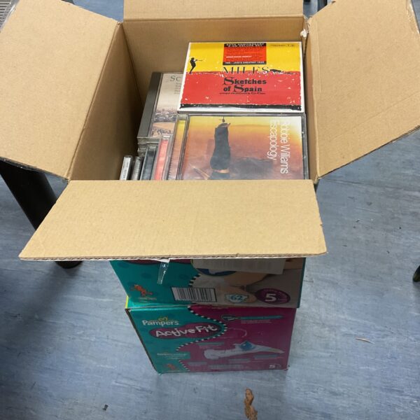 Two boxes filled with a vintage music CD collection for audio enthusiasts.