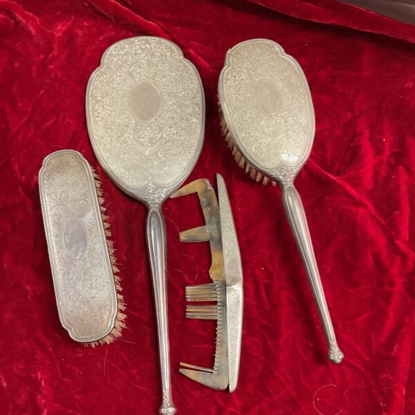 Antique silver dressing table set with mirror, brush and comb.