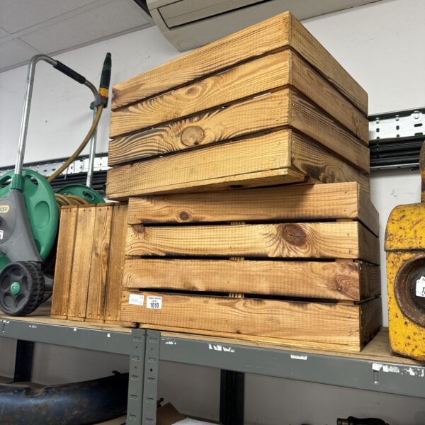 Stack of three vintage wooden tea crates for storage.
