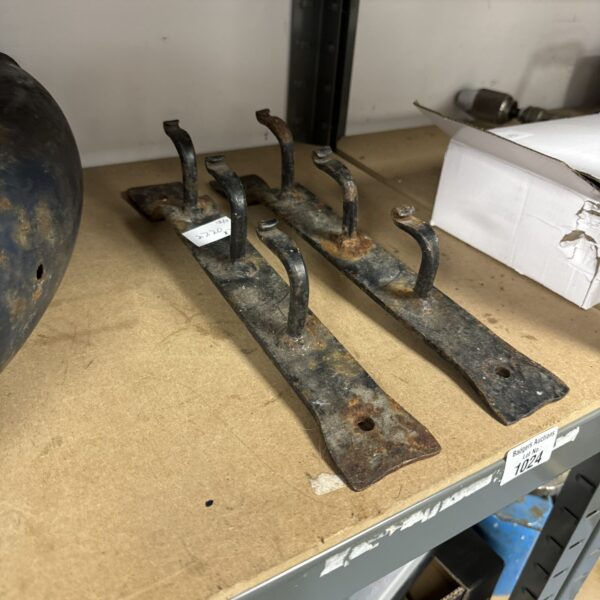 Antique wrought iron brackets with scrolled detailing, vintage hardware.