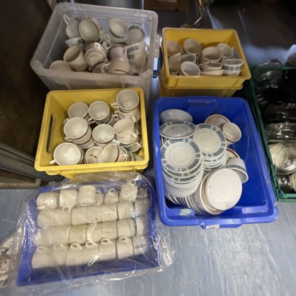 Boxes of assorted vintage china cups and saucers.
