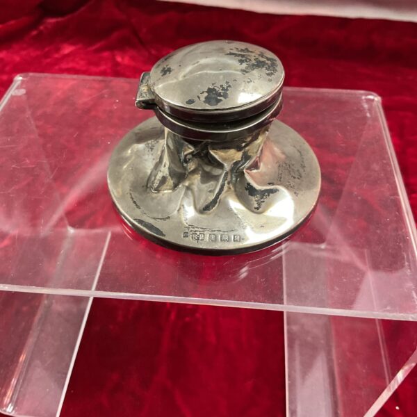 Antique silver capstan inkwell, a vintage desk accessory.