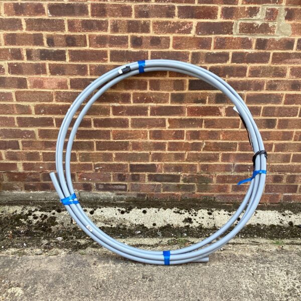 Coil of flexible plastic water pipe for garden or plumbing use.