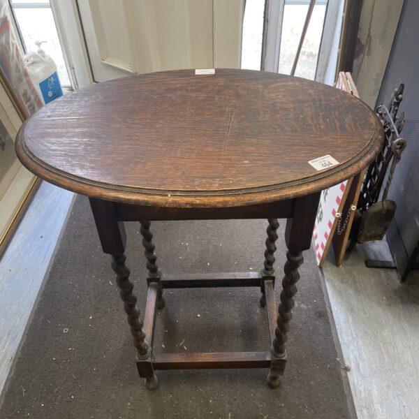 Antique barley twist oak oval occasional table with carved legs.