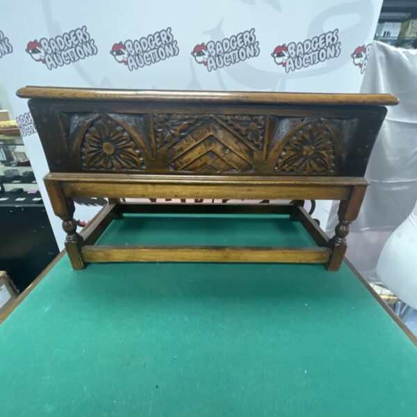 Vintage small oak coffer with carved detailing, front view.
