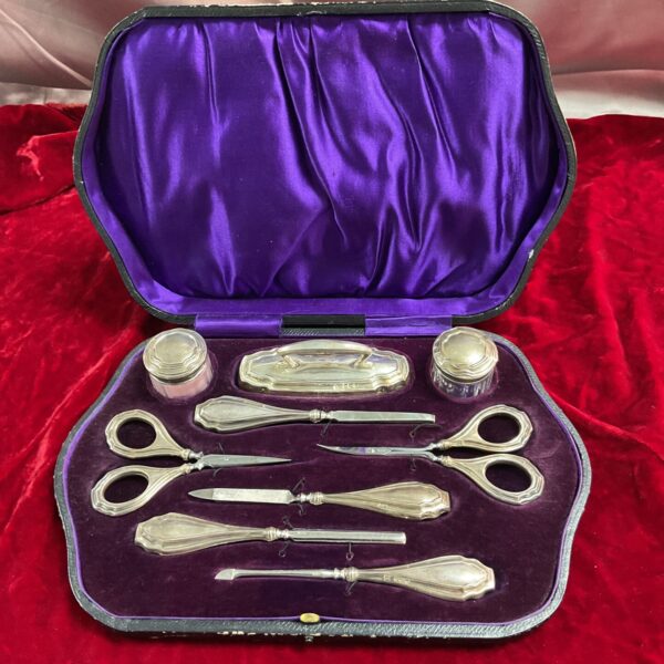 Open antique sterling silver manicure set in velvet box.