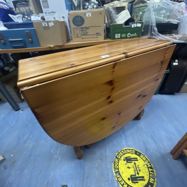 Antique pine gate leg table with drop leaf design.