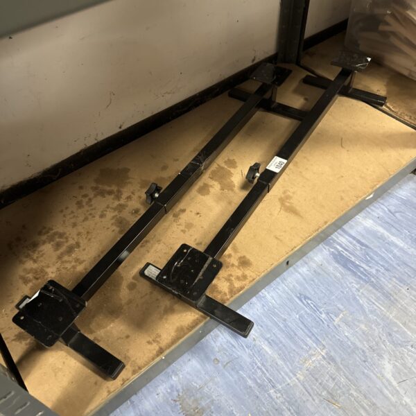 Metal chair risers pair for elevating furniture.
