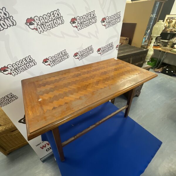 Vintage parquetry coffee table with geometric wood inlay.