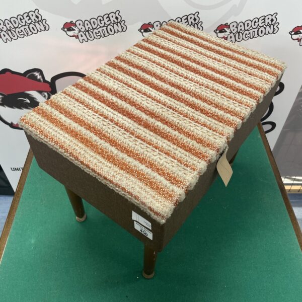 Vintage sewing stool with striped upholstery and wooden legs.