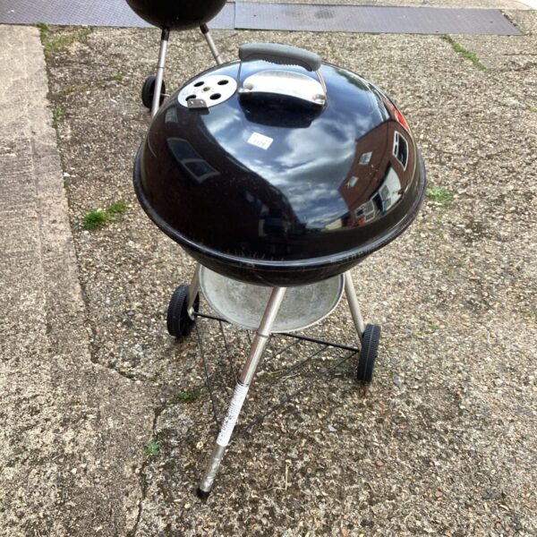 Vintage Weber drum BBQ in a garden setting.