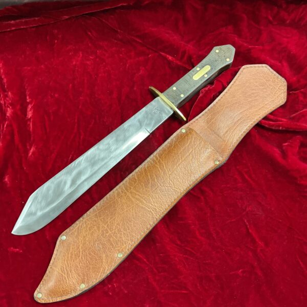 Antique coffin handle Bowie knife with leather sheath.