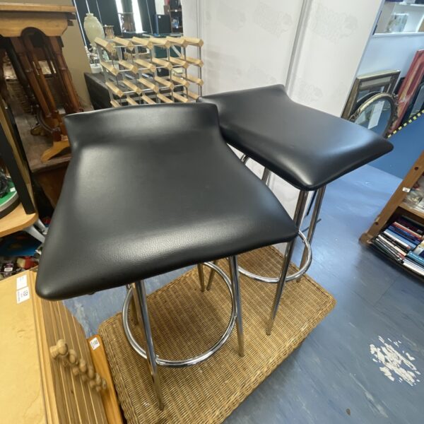 Pair of vintage black cushioned stools with chrome legs.