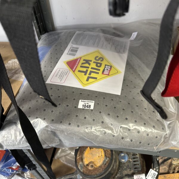 Sealed spill kit with absorbent pads for liquid cleanup.