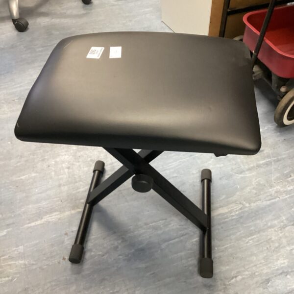 Adjustable piano stool with leather seat for musicians.