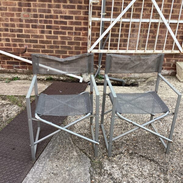 Pair of folding garden chairs with mesh seats for outdoor use.