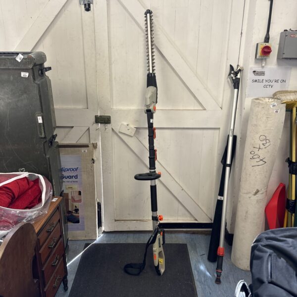 Von Haus cordless pole hedge cutter in a garden setting.