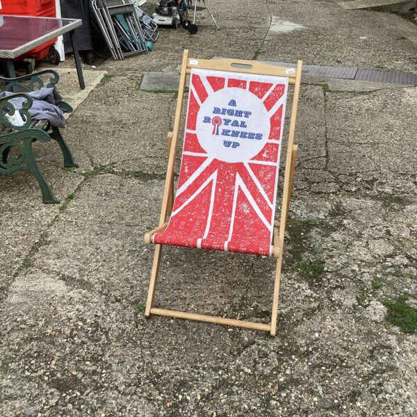 Bright red and white striped vintage folding deck chair.